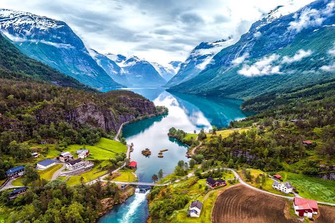 Norwegian fjords with cruise ship and steep cliffs